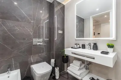 a bathroom with a toilet and a sink and a mirror at Design Flat in Porto Downtown II in Porto
