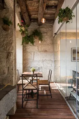 a bedroom with a bed with a yellow blanket on it at Alma das Taipas Apartment in Porto