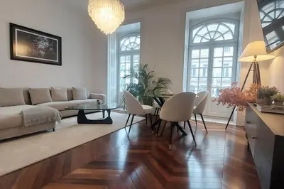 a living room with a couch and a table and chairs at Dream on - Clérigos Tower in Porto