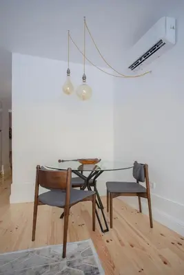 a glass table and a chair in a room at Liiiving in Porto - Clérigos Terrace Apartment in Porto