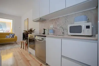 a kitchen with a microwave on a counter top at Liiiving in Porto - Clérigos Terrace Apartment in Porto