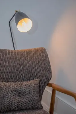 a lamp sitting next to a chair in a room at Liiiving in Porto - Clérigos Terrace Apartment in Porto