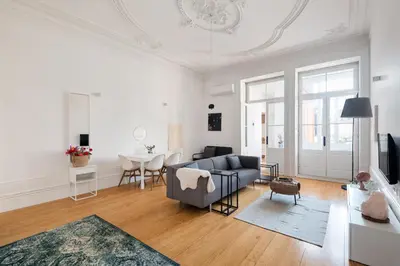 a living room with a couch and a table at MARKES · Lovely 1-bedroom home w/ sunny backyard in Porto