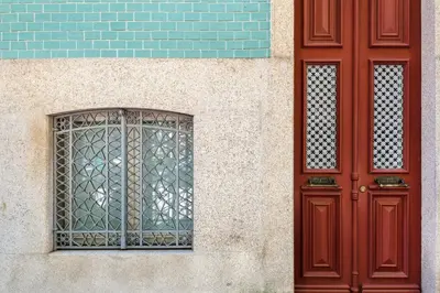a building with a red door and a window at MARKES · Lovely 1-bedroom home w/ sunny backyard in Porto