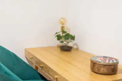 a wooden coffee table with a plant on top of it at Aliados luxurious home in Porto