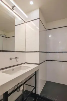 a white bathroom with a sink and a mirror at Aliados luxurious home in Porto