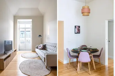 a living room and a dining room with a couch and a table at Aliados luxurious home in Porto