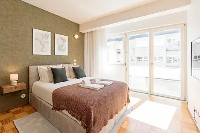 a bedroom with a bed and a large window at Ceuta Studio Apartments by LovelyStay in Porto
