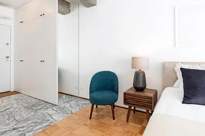 a bedroom with a bed and a chair and a table at Ceuta Studio Apartments by LovelyStay in Porto