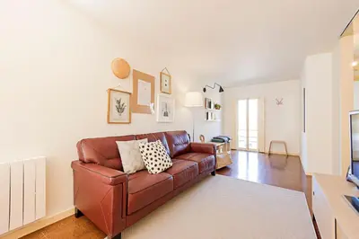 a living room with a brown leather couch at Casa 128 by LovelyStay in Porto