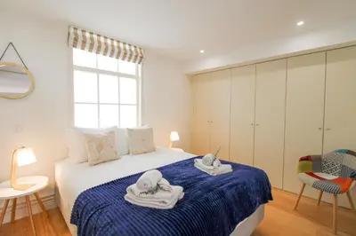 a bedroom with a bed with towels on it at Porto Unique Cosy Duplex in Porto