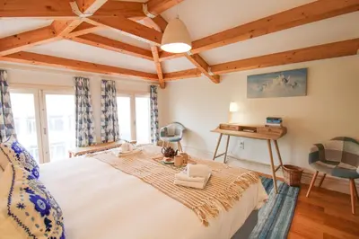 a bedroom with a large bed and a desk at Porto Unique Cosy Duplex in Porto