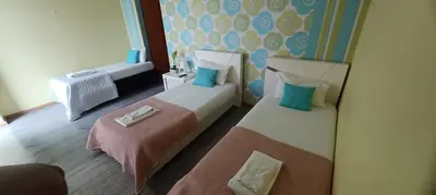 a hotel room with two beds and a chair at We are tourist in Vila Nova de Gaia