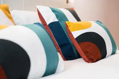 a group of pillows sitting on a bed at GuestReady - Miragaia Stone Studios & Apartments in Porto