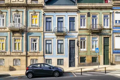 a black car parked in front of a building at Stylish Downtown Apartment in Porto