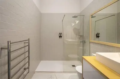 a bathroom with a toilet and a sink at Stylish Downtown Apartment in Porto