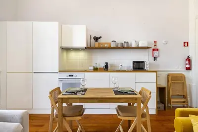 a room with a hallway with chairs and a table at Stylish Downtown Apartment in Porto