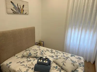 a bed with a bag sitting on top of it at Francisca City House in Vila Nova de Gaia