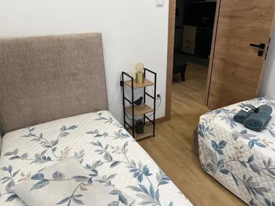 a bedroom with two beds and a mirror at Francisca City House in Vila Nova de Gaia