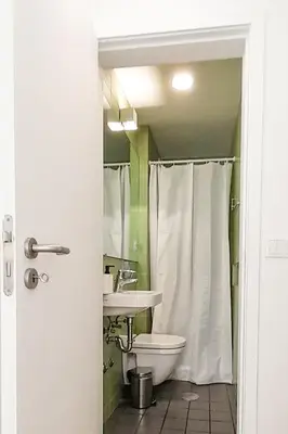 a bathroom with a white toilet and a sink at PORTO CONCEPT HOME - Campo Alegre in Porto