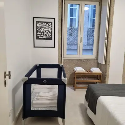 a room with a bed and a window and a drawer at Neo Porto Family & Friends in Porto