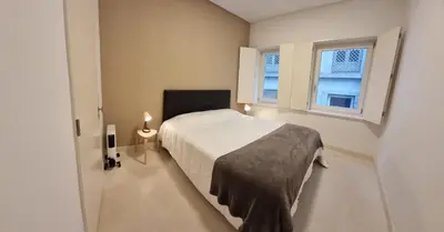 a bedroom with a white bed and two windows at Neo Porto Family & Friends in Porto