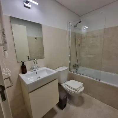 a bathroom with a toilet and a sink and a shower at Neo Porto Family & Friends in Porto