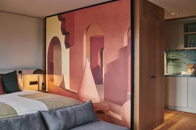 a bedroom with a bed with a painting on the wall at Prim&Proper in Porto