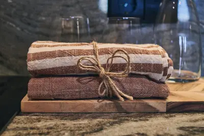 a stack of towels sitting on a cutting board at Prim&Proper in Porto