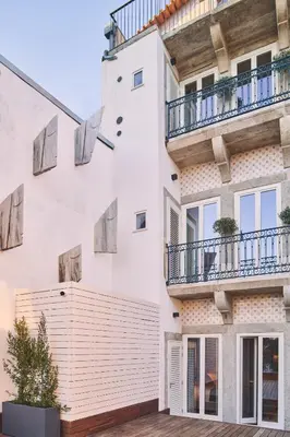 an apartment building with white walls and balconies at Prim&Proper in Porto