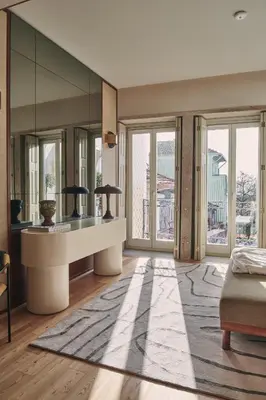 a living room with a table and some windows at Prim&Proper in Porto