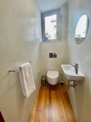 a white bathroom with a sink and a toilet at Padre António Vieira flat E - 2 Bedroom Near Campanhã train station in Porto