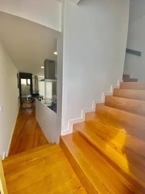 a hallway with stairs and wooden floors in a house at Padre António Vieira flat E - 2 Bedroom Near Campanhã train station in Porto