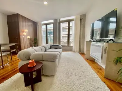 a living room with a couch and a tv at Padre António Vieira flat E - 2 Bedroom Near Campanhã train station in Porto