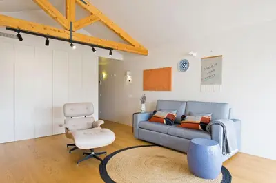 a living room with a couch and a chair at Boutique Rentals-Primrose Terrace&Garage in Porto