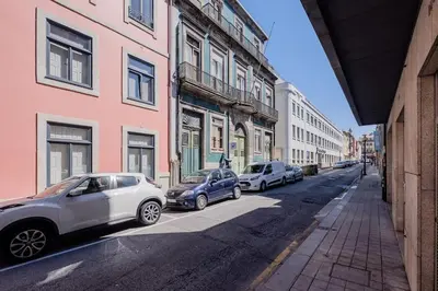 a row of cars parked on a street next to buildings at Boutique Rentals-Primrose Terrace&Garage in Porto