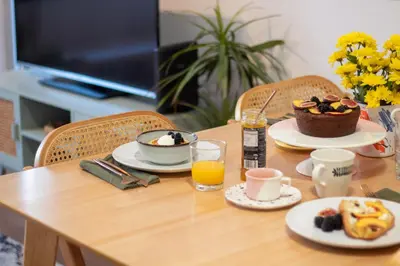 a table with breakfast food and a bowl of fruit at Campinho 1T - Stylish 1BR by LovelyStay in Porto