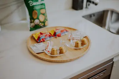 a wooden cutting board with glasses and snacks on a counter at Login Luxury Apartment in Porto