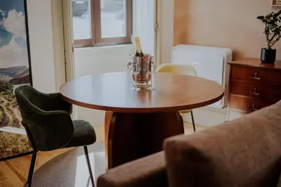 a table with a wine glass on it in a room at Login Luxury Apartment in Porto
