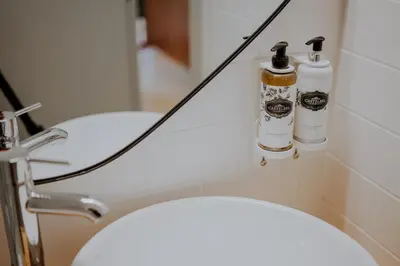 a bathroom with a toilet with two bottles on it at Login Luxury Apartment in Porto