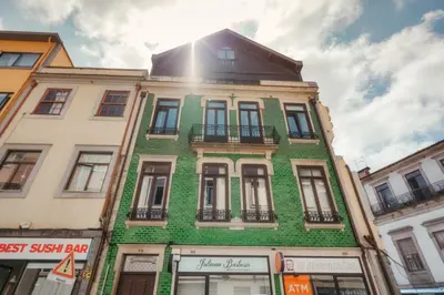 a green building on a city street at Login Luxury Apartment in Porto