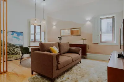 a living room with a couch and a bed at Login Luxury Apartment in Porto
