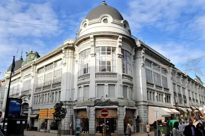 a large white building with a dome on a street at Login Luxury Apartment in Porto