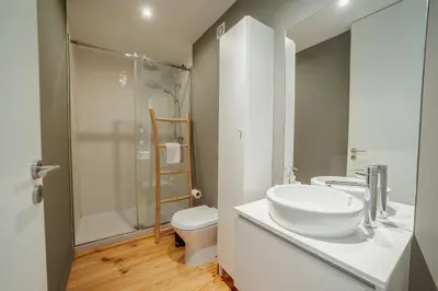 a bathroom with a sink and a toilet and a shower at Downtown Excellence Apartment by Vacationy in Porto