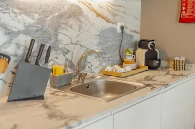 a kitchen counter with a sink and a counter top with a counter at Downtown Excellence Apartment by Vacationy in Porto