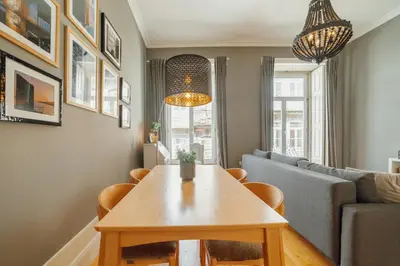 a living room with a table and a couch at Downtown Excellence Apartment by Vacationy in Porto