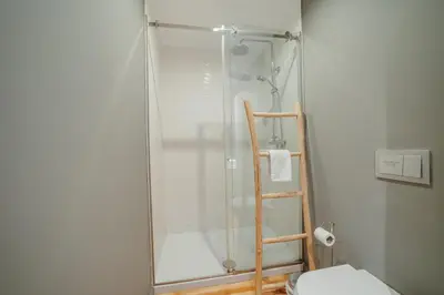 a shower with a glass door in a bathroom at Downtown Excellence Apartment by Vacationy in Porto
