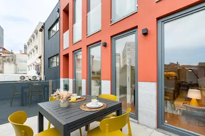 a dining room with a table and yellow chairs at Fontainhas Elite Apartments in Porto