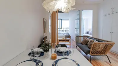 a living room with a table and a couch at Fernandes Tomás 424 by LovelyStay in Porto
