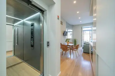 a hallway with a glass door leading to a dining room at 31 de Janeiro Flat by Amber Star Rent in Porto